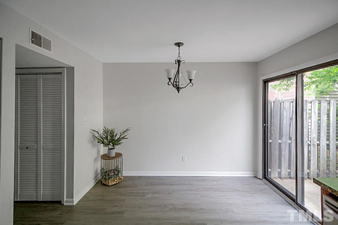5840 Shady Grove Circle Raleigh, NC 27609 - Photo 6 of 18 a view of a room with a potted plant a ceiling fan and window