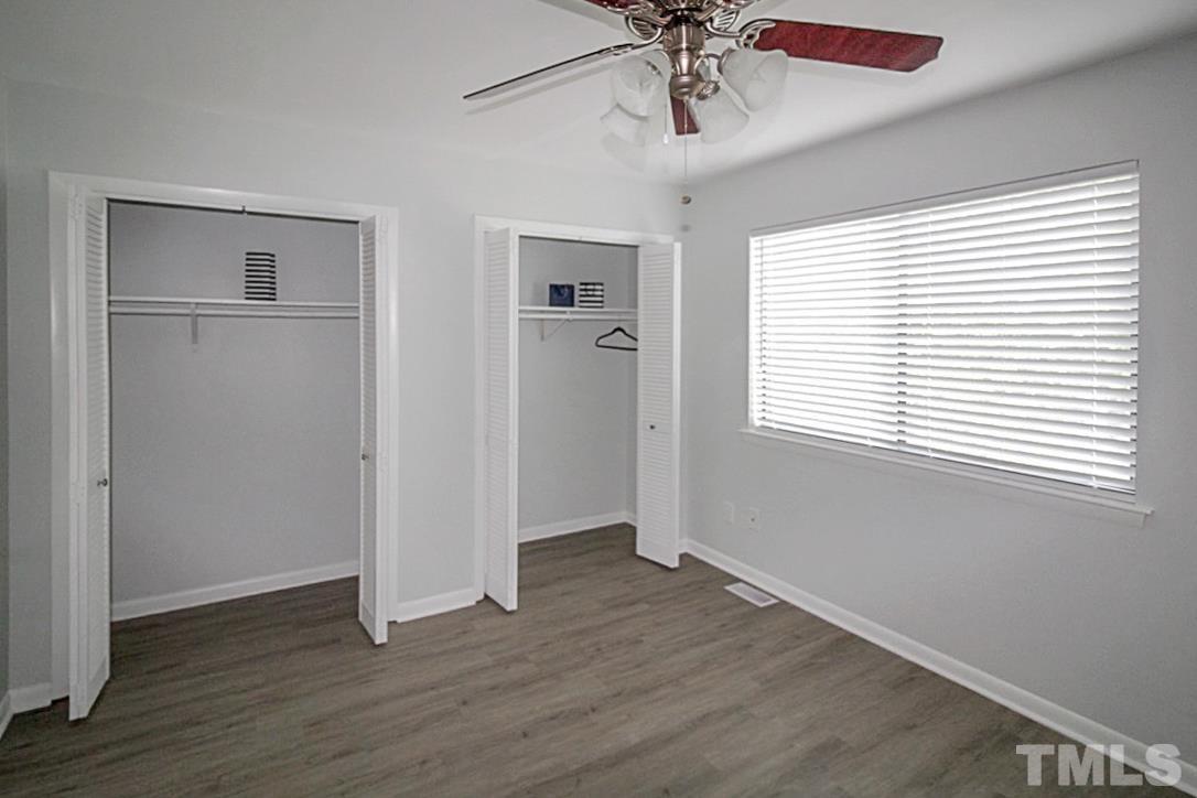 5840 Shady Grove Circle Raleigh, NC 27609 - Photo 8 of 18 a view of an empty room with a window and wooden floor