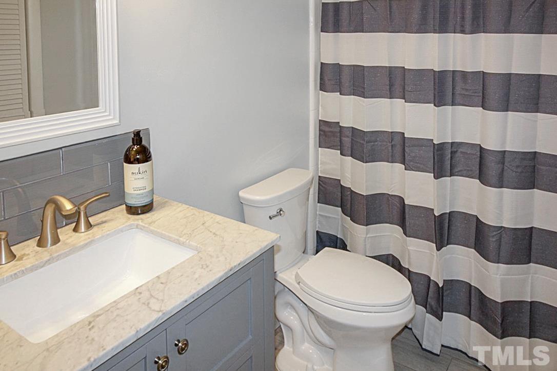5840 Shady Grove Circle Raleigh, NC 27609 - Photo 10 of 18 a bathroom with a sink toilet and shower
