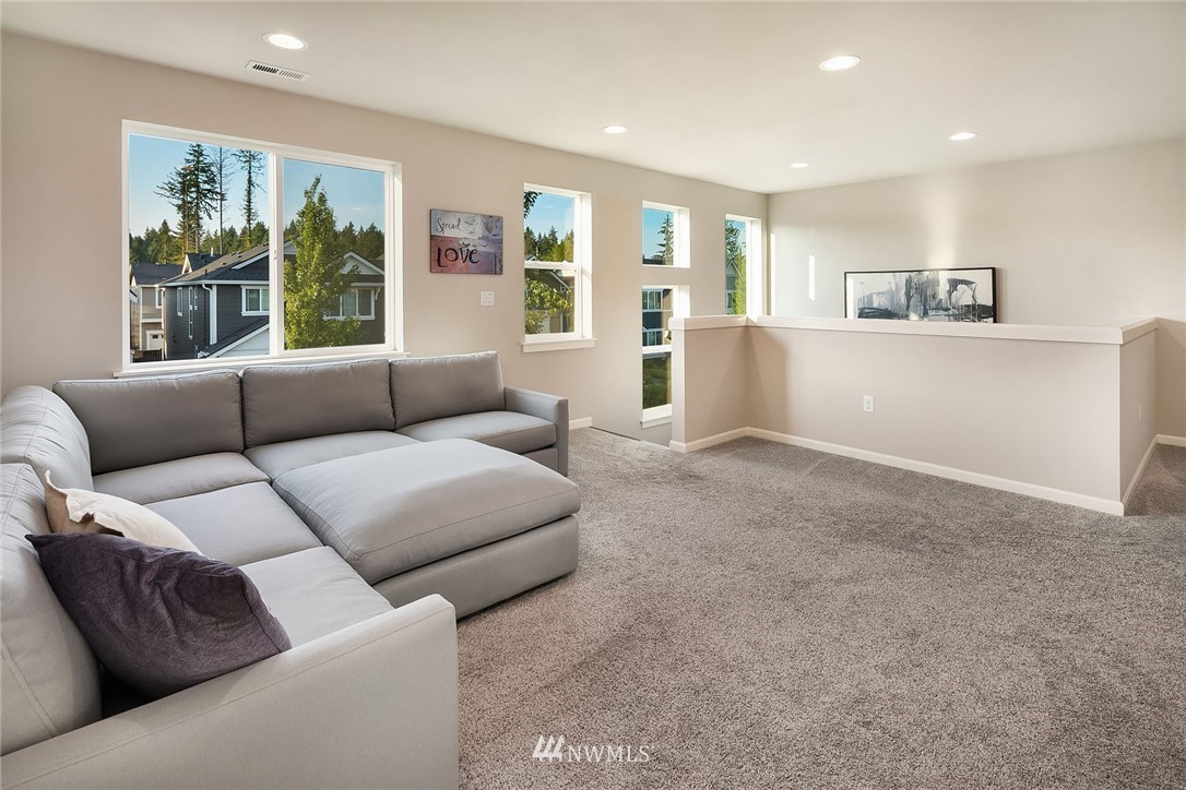 18607 45th Avenue Southeast Bothell, WA 98012 - Photo 12 of 23 a living room with furniture and a large window