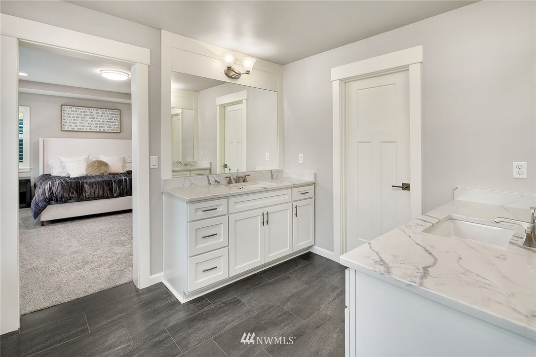 18607 45th Avenue Southeast Bothell, WA 98012 - Photo 14 of 23 a spacious bathroom with a granite countertop sink and a mirror