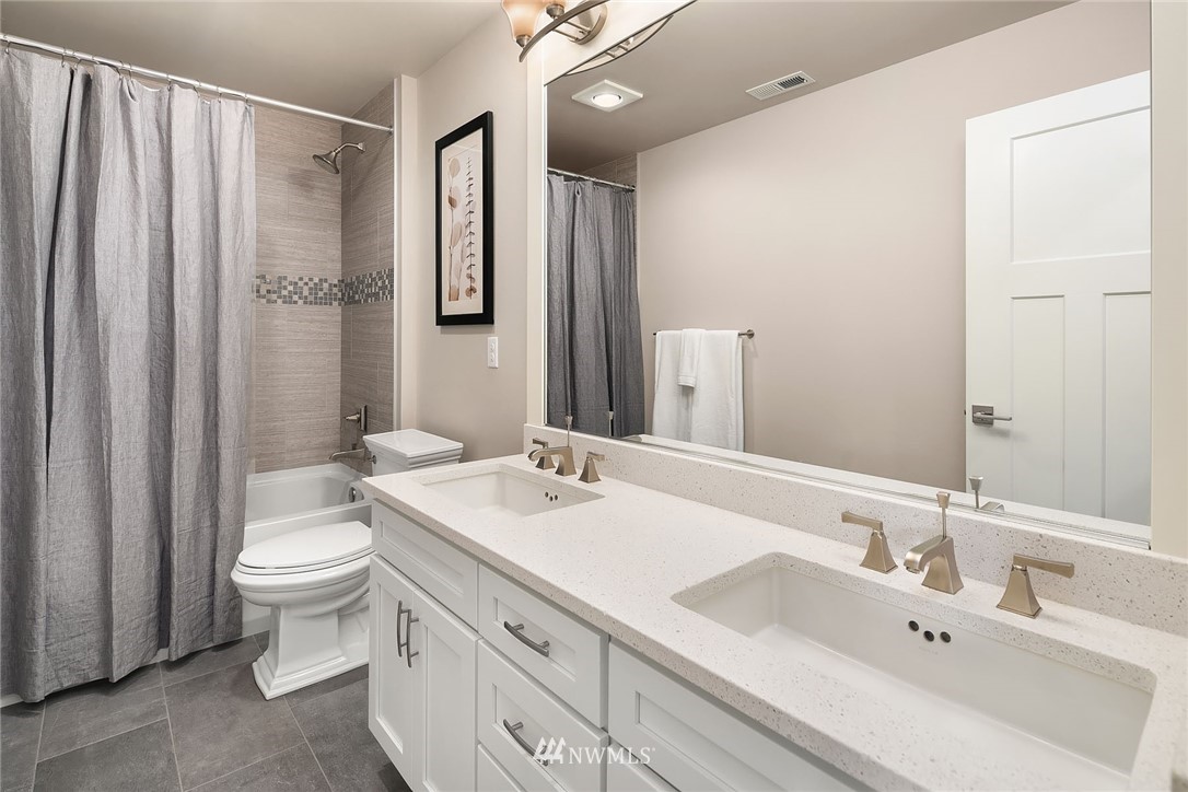 18607 45th Avenue Southeast Bothell, WA 98012 - Photo 18 of 23 a bathroom with a double vanity sink toilet and a mirror