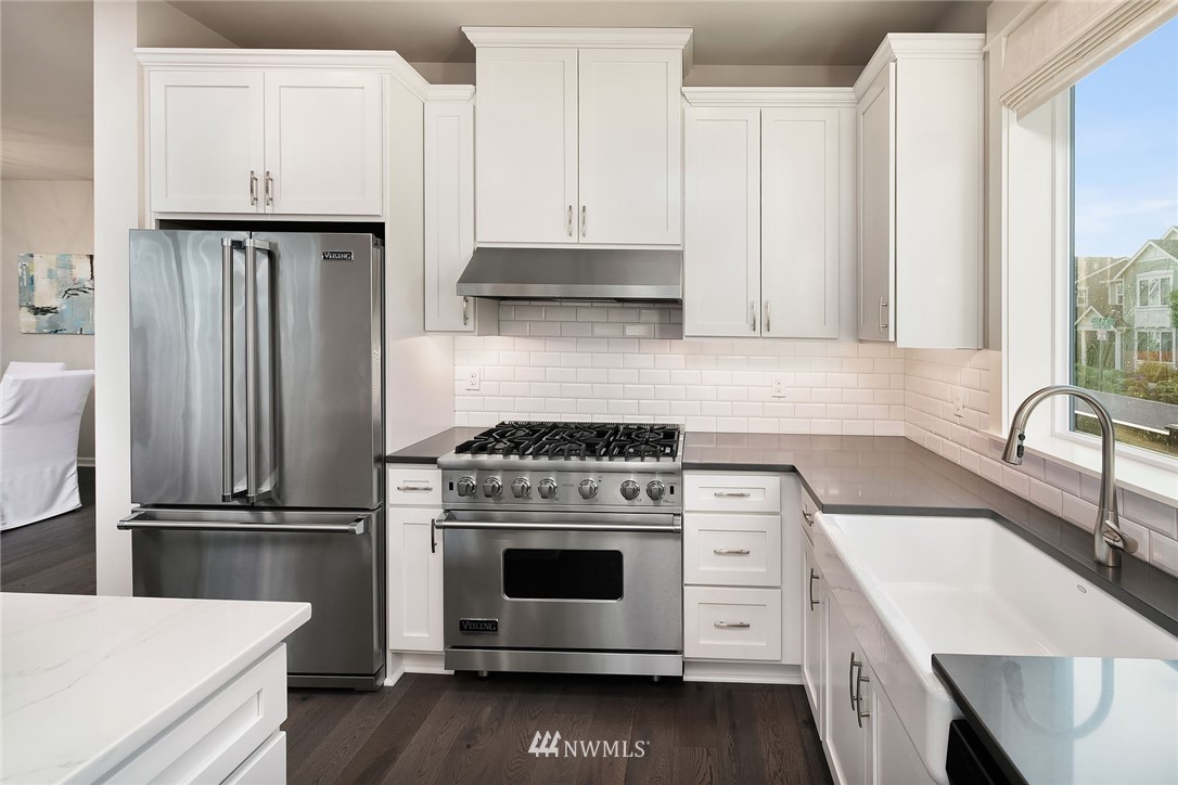18607 45th Avenue Southeast Bothell, WA 98012 - Photo 5 of 23 a kitchen with granite countertop a stove oven and sink