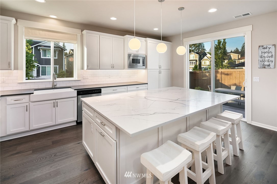 18607 45th Avenue Southeast Bothell, WA 98012 - Photo 6 of 23 a large kitchen with stainless steel appliances kitchen island a large island in the center