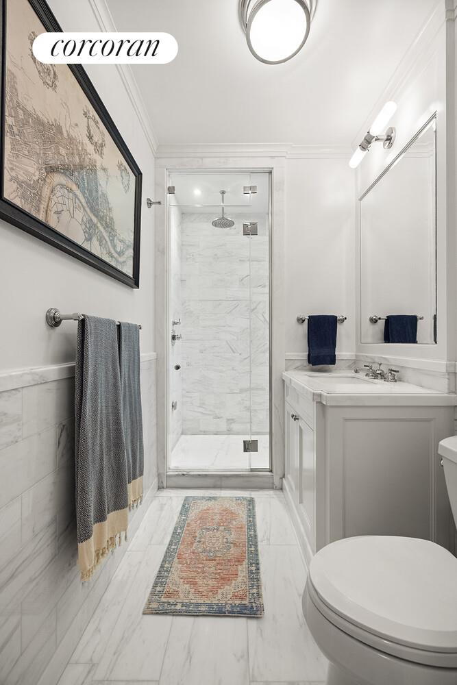 16 East 96th Street, Unit 7B Manhattan, NY 10128 - Photo 17 of 55 a bathroom with a toilet sink a shower and a mirror