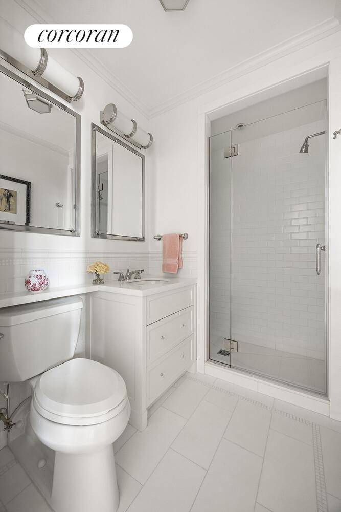 16 East 96th Street, Unit 7B Manhattan, NY 10128 - Photo 26 of 55 a bathroom with a sink a toilet and shower