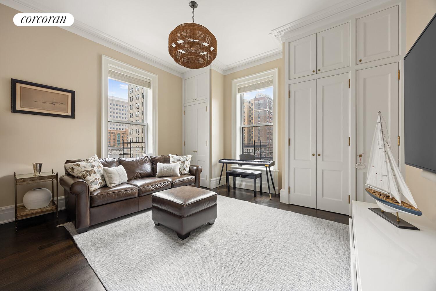 16 East 96th Street, Unit 7B Manhattan, NY 10128 - Photo 27 of 55 a living room with furniture a fireplace and a large window