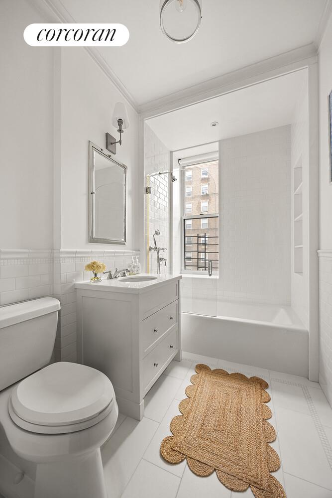 16 East 96th Street, Unit 7B Manhattan, NY 10128 - Photo 28 of 55 a bathroom with a sink toilet and mirror