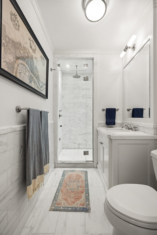 16 East 96th Street, Unit 7B Manhattan, NY 10128 - Photo 42 of 55 a bathroom with a toilet sink and shower