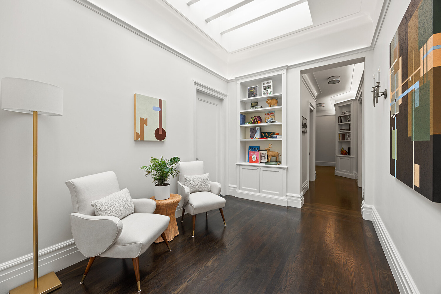 16 East 96th Street, Unit 7B Manhattan, NY 10128 - Photo 44 of 55 a living room with furniture and a book shelf