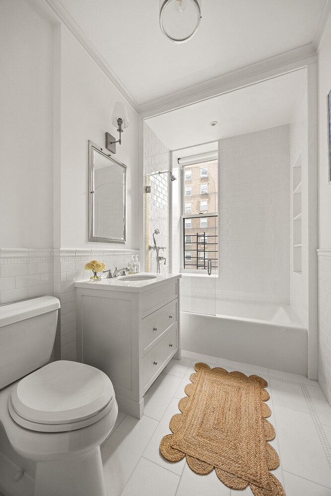 16 East 96th Street, Unit 7B Manhattan, NY 10128 - Photo 51 of 55 a bathroom with a sink toilet and mirror