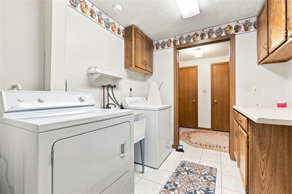Laundry area with counter space and cabinetry.