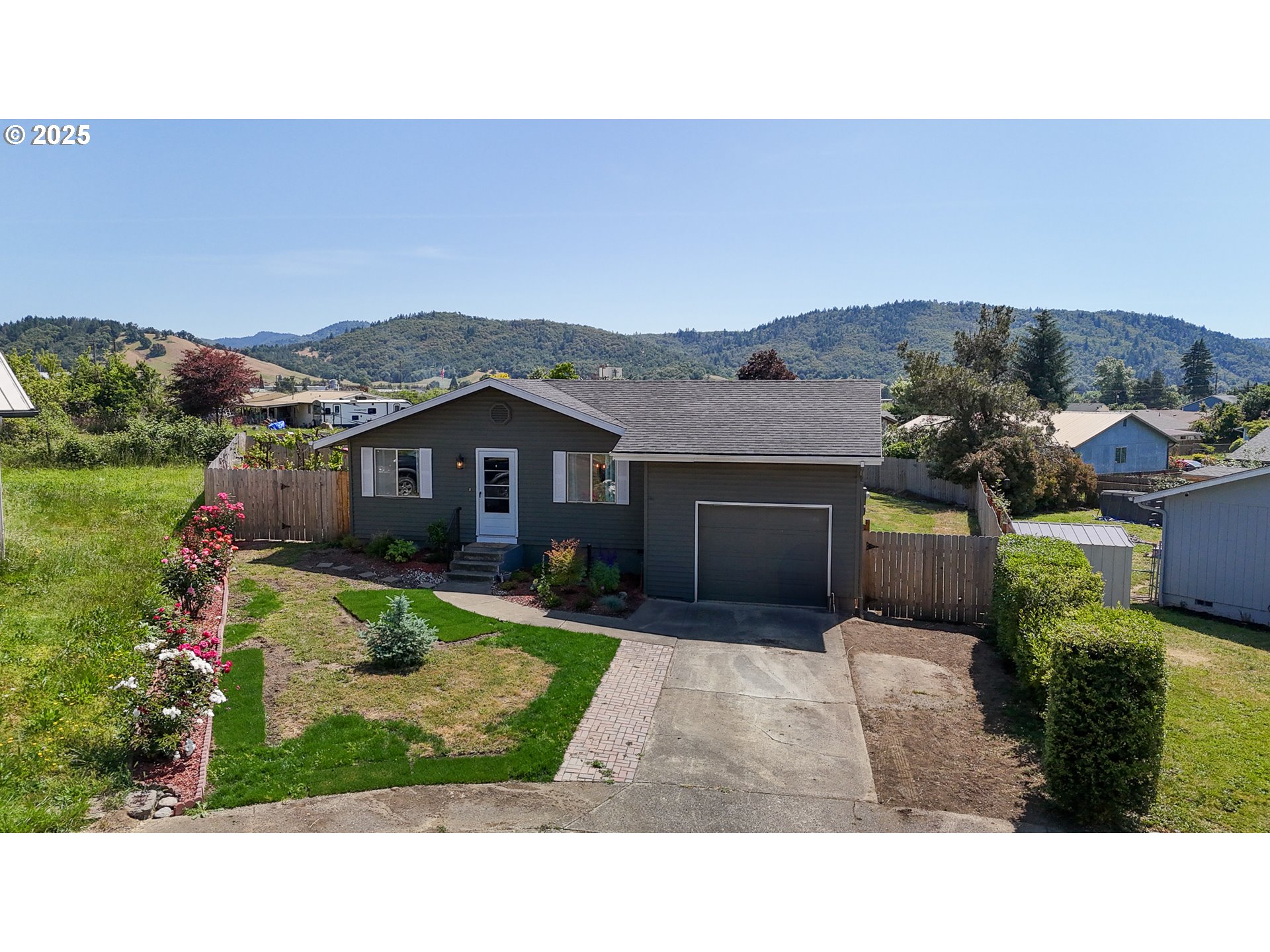 715 Penny Lane Riddle, OR 97469 - Photo 1 of 32 a house view with a garden space