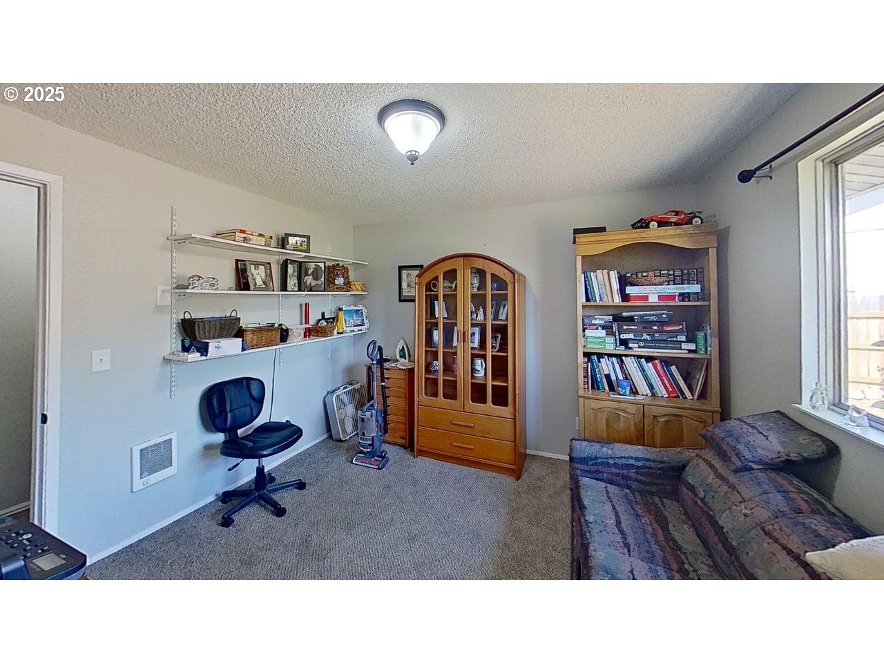 715 Penny Lane Riddle, OR 97469 - Photo 6 of 32 a living room with furniture and a book shelf
