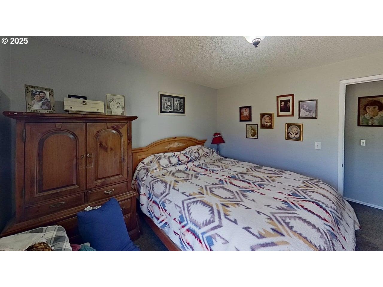 715 Penny Lane Riddle, OR 97469 - Photo 7 of 32 a bedroom with a bed and painting on the wall