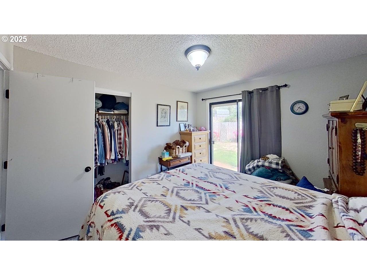 715 Penny Lane Riddle, OR 97469 - Photo 8 of 32 a bedroom with a bed and a dresser