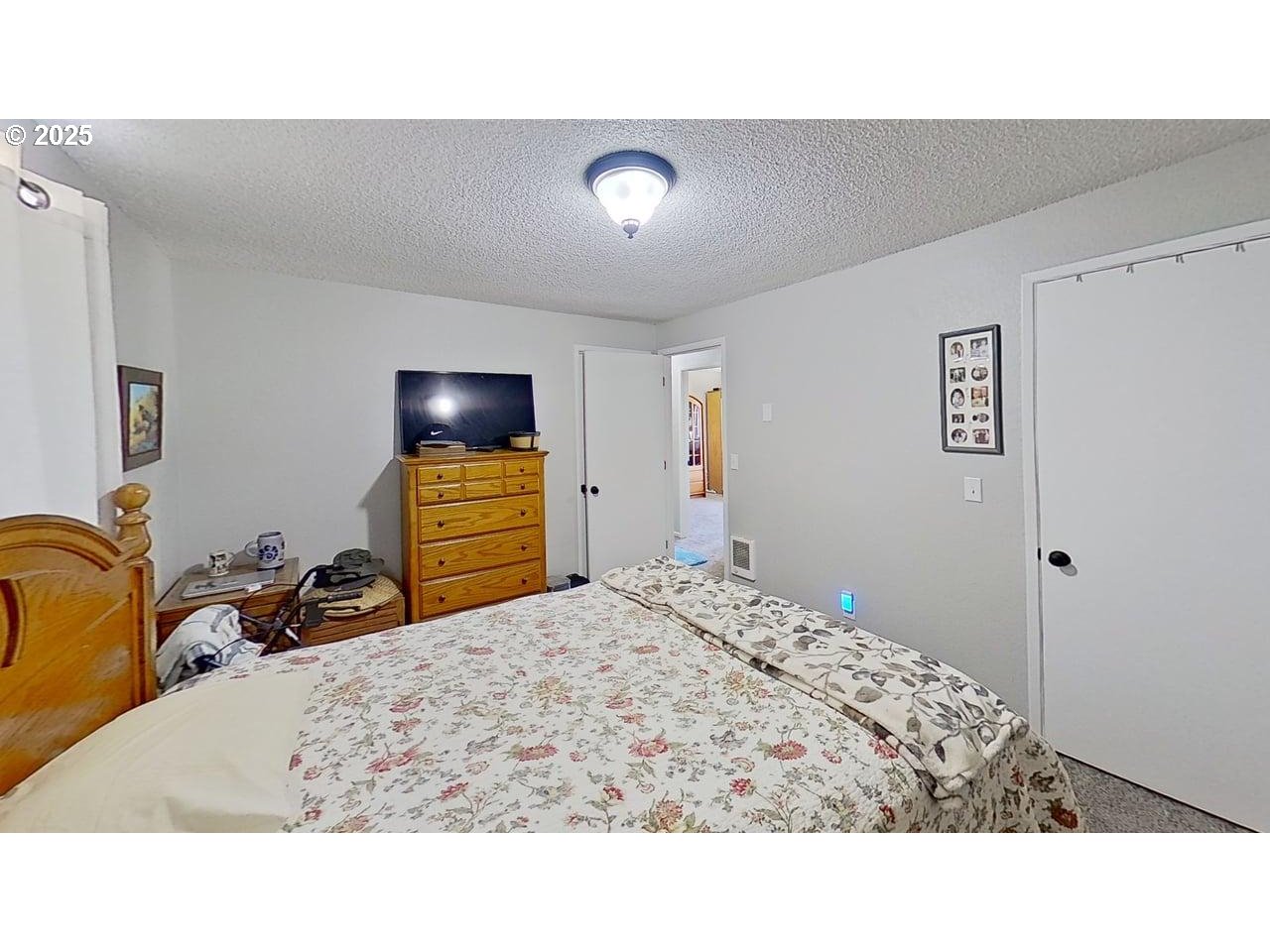 715 Penny Lane Riddle, OR 97469 - Photo 9 of 32 a bedroom with a bed and a mirror