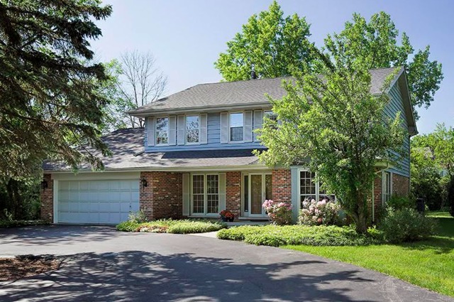 401 Voltz Road Northbrook, IL 60062 - Photo 1 of 13 a front view of a house with a yard and garage
