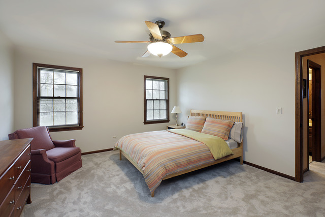 401 Voltz Road Northbrook, IL 60062 - Photo 8 of 13 a bedroom with a bed couch and window