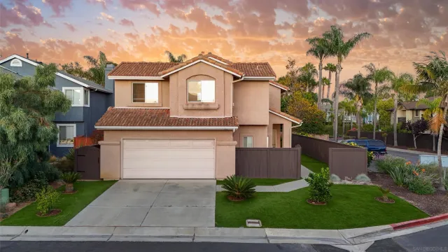 a front view of a house with a garden and plants