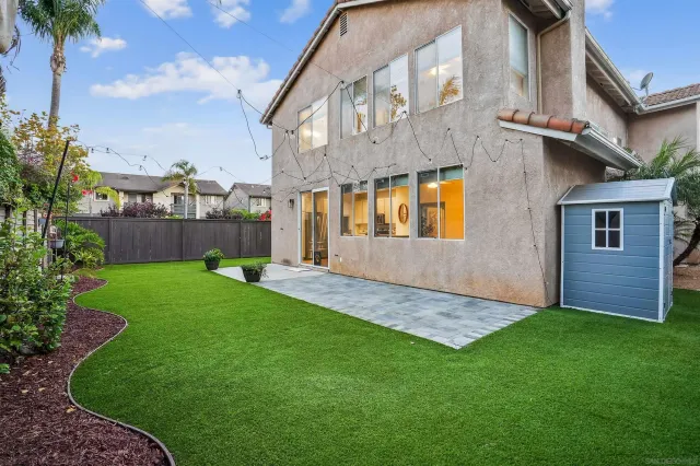 a front view of a house with a garden and yard