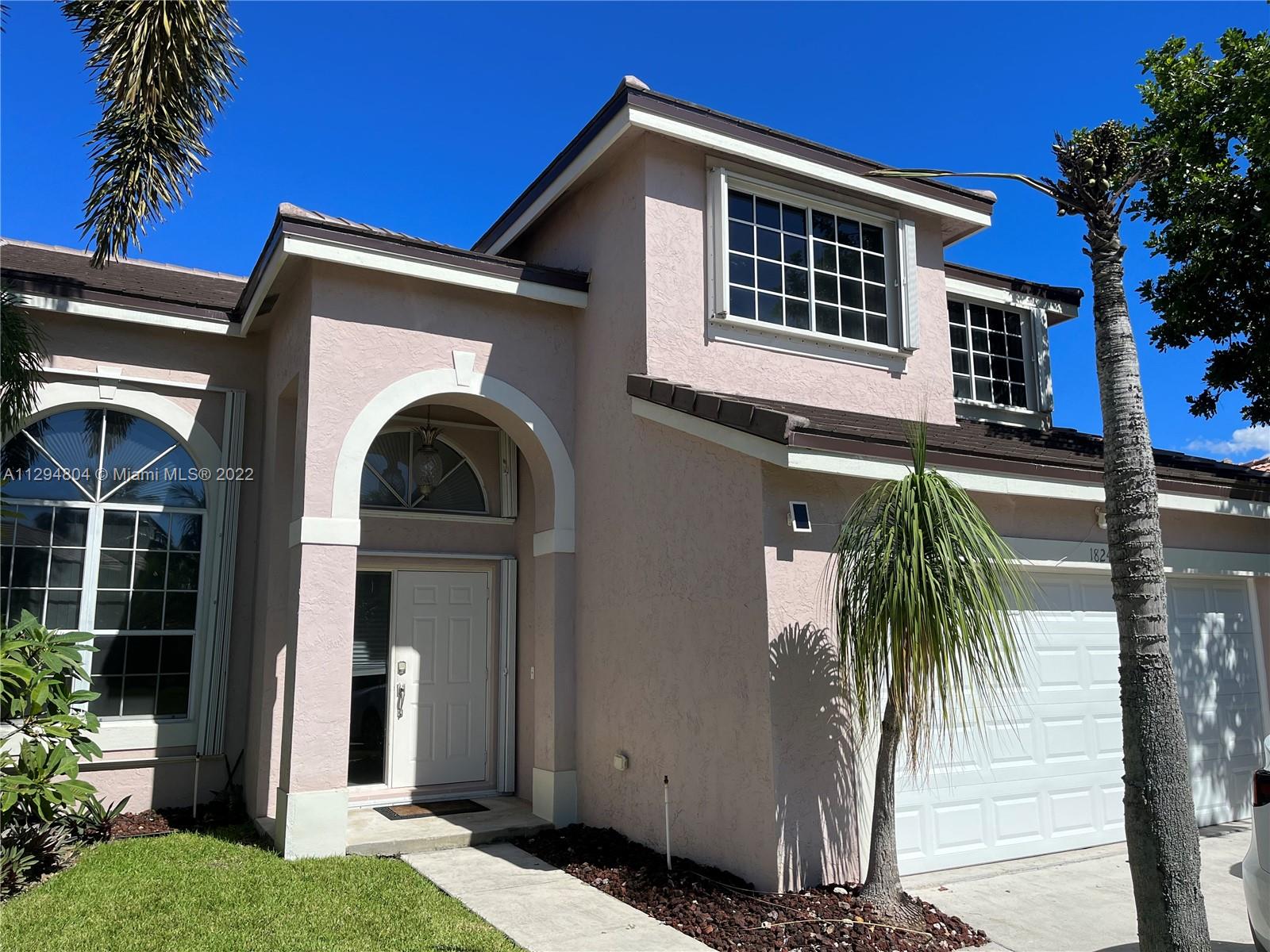 18249 Southwest 3rd Street Pembroke Pines, FL 33029 - Photo 1 of 40 a view of a house with a yard and plants
