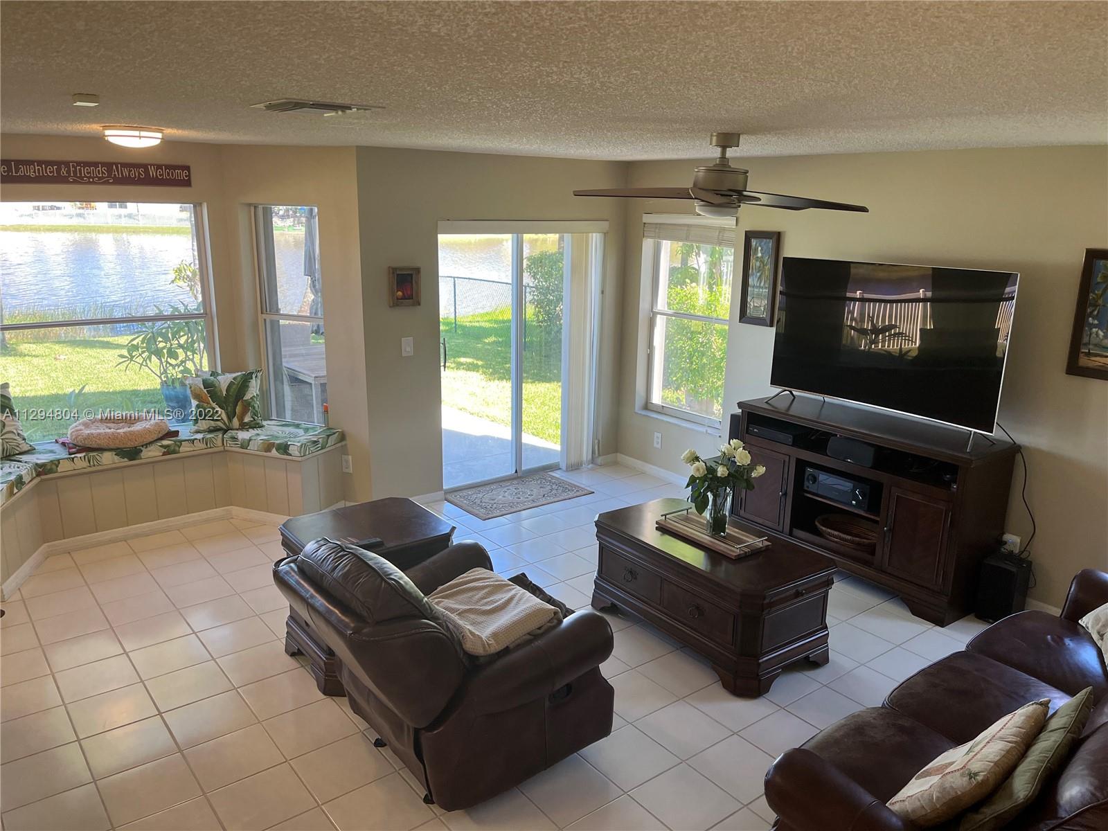 18249 Southwest 3rd Street Pembroke Pines, FL 33029 - Photo 11 of 40 a living room with furniture and a flat screen tv