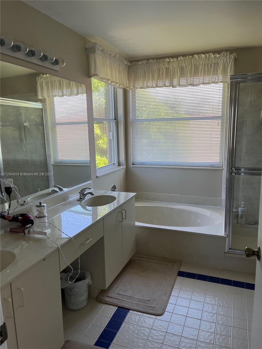 18249 Southwest 3rd Street Pembroke Pines, FL 33029 - Photo 13 of 40 a bathroom with a tub sink and mirror