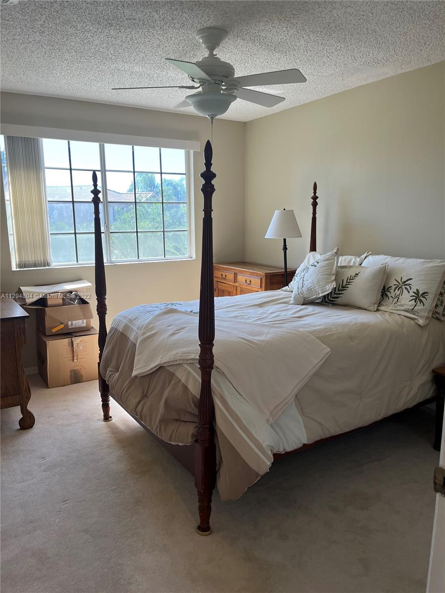 18249 Southwest 3rd Street Pembroke Pines, FL 33029 - Photo 14 of 40 a bedroom with a bed dresser with a large window
