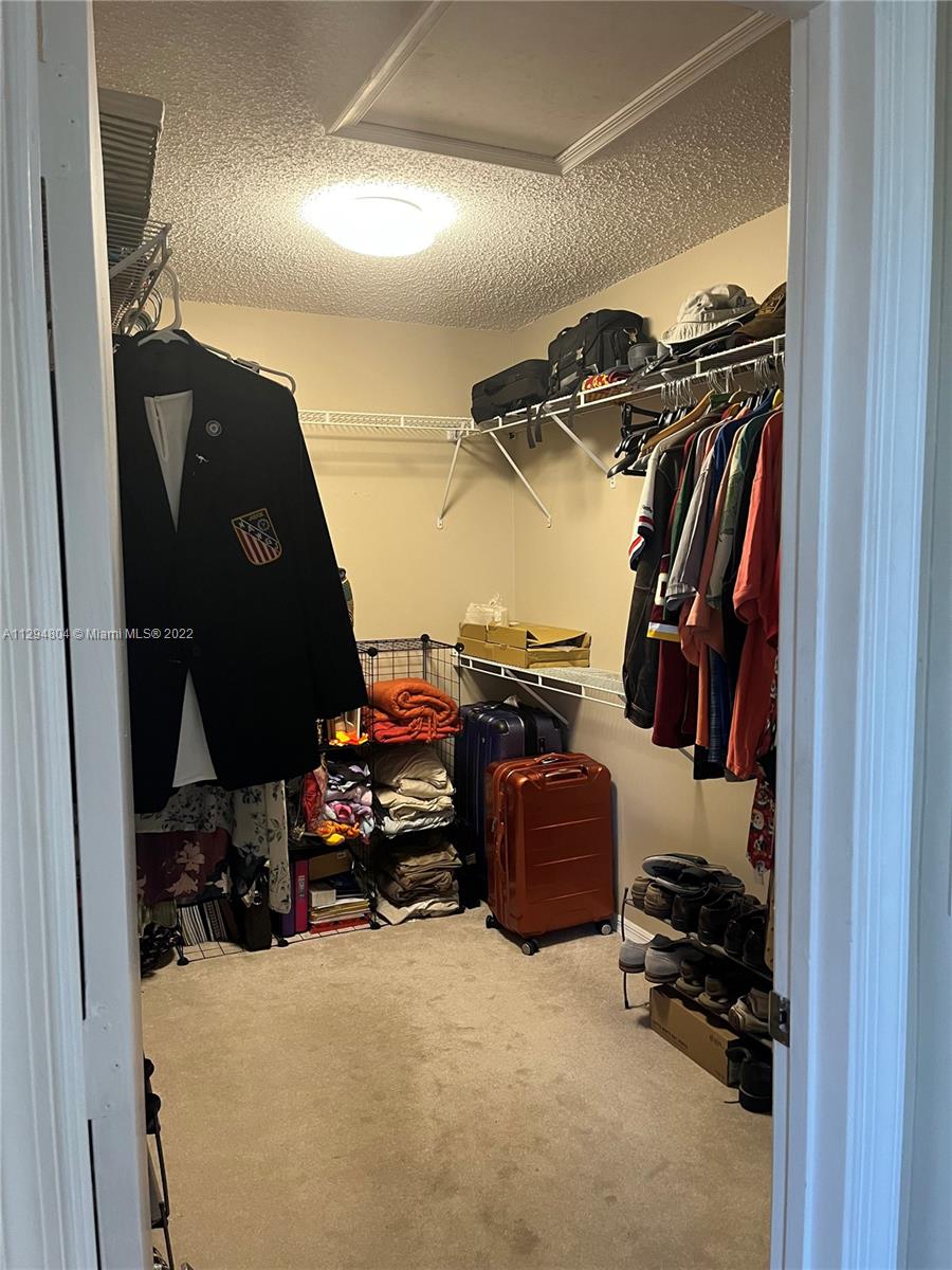 18249 Southwest 3rd Street Pembroke Pines, FL 33029 - Photo 15 of 40 a view of walk in closet with clothes and shoes