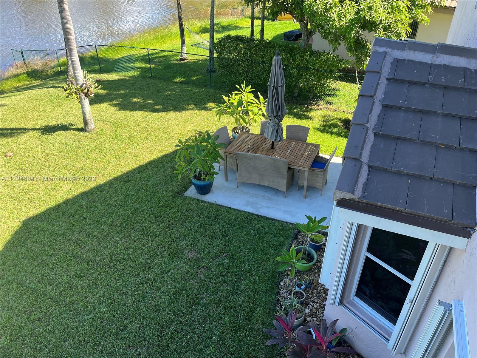 18249 Southwest 3rd Street Pembroke Pines, FL 33029 - Photo 16 of 40 a view of a backyard with plants and a patio
