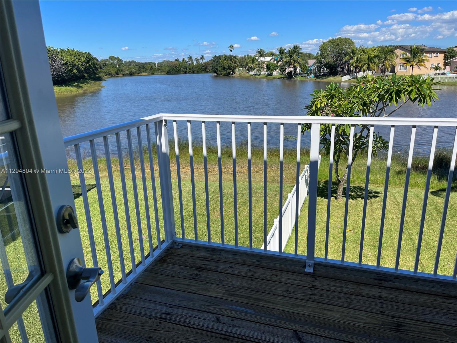 18249 Southwest 3rd Street Pembroke Pines, FL 33029 - Photo 18 of 40 a view of a balcony with lake view and wooden floor