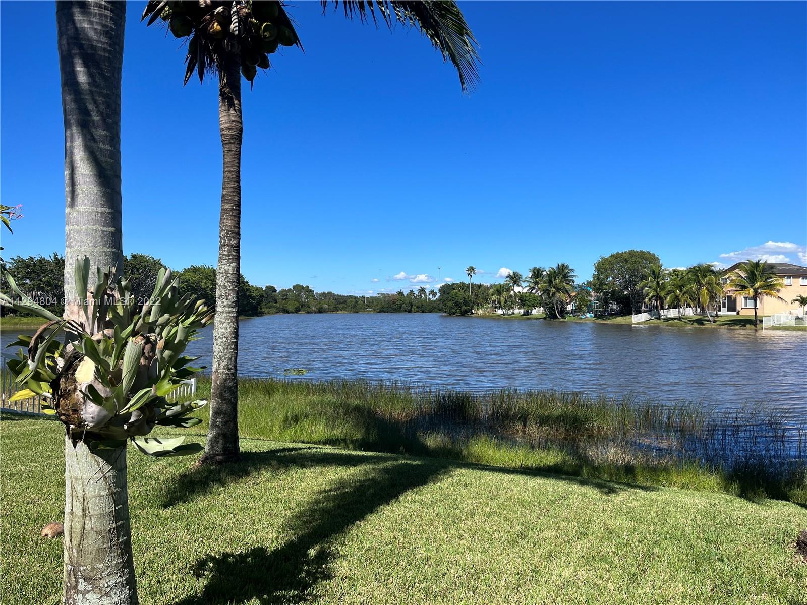 18249 Southwest 3rd Street Pembroke Pines, FL 33029 - Photo 20 of 40 a view of a lake with a house in a background