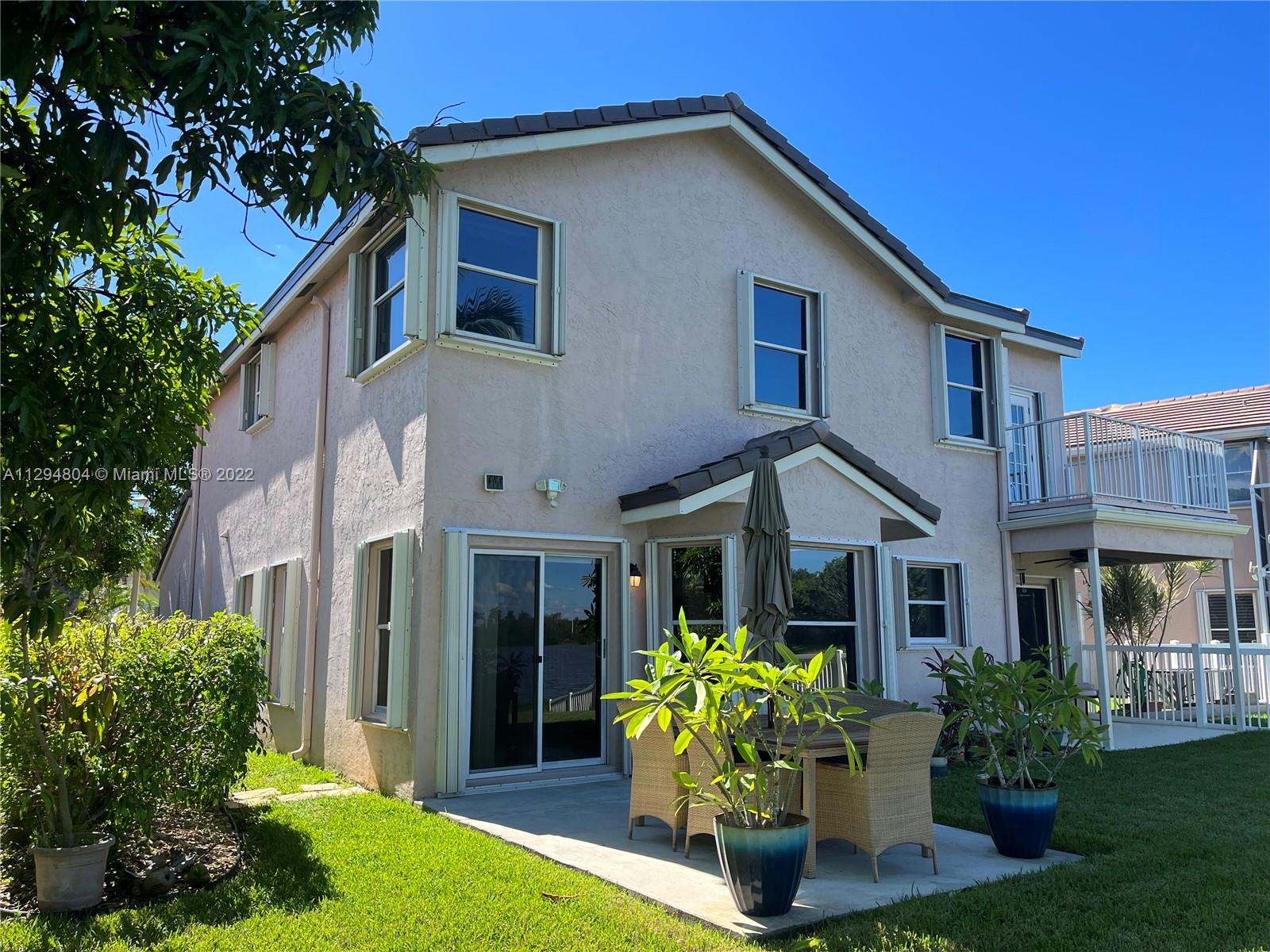 18249 Southwest 3rd Street Pembroke Pines, FL 33029 - Photo 22 of 40 a front view of a house with porch and garden