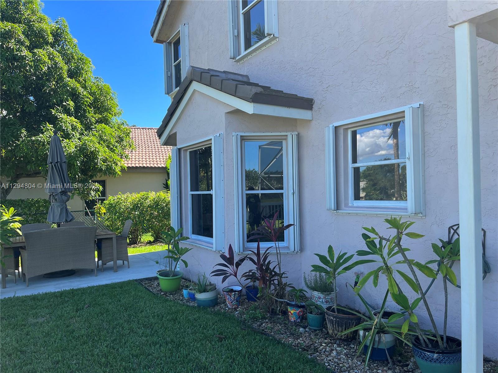 18249 Southwest 3rd Street Pembroke Pines, FL 33029 - Photo 24 of 40 a view of house with backyard outdoor seating and garden