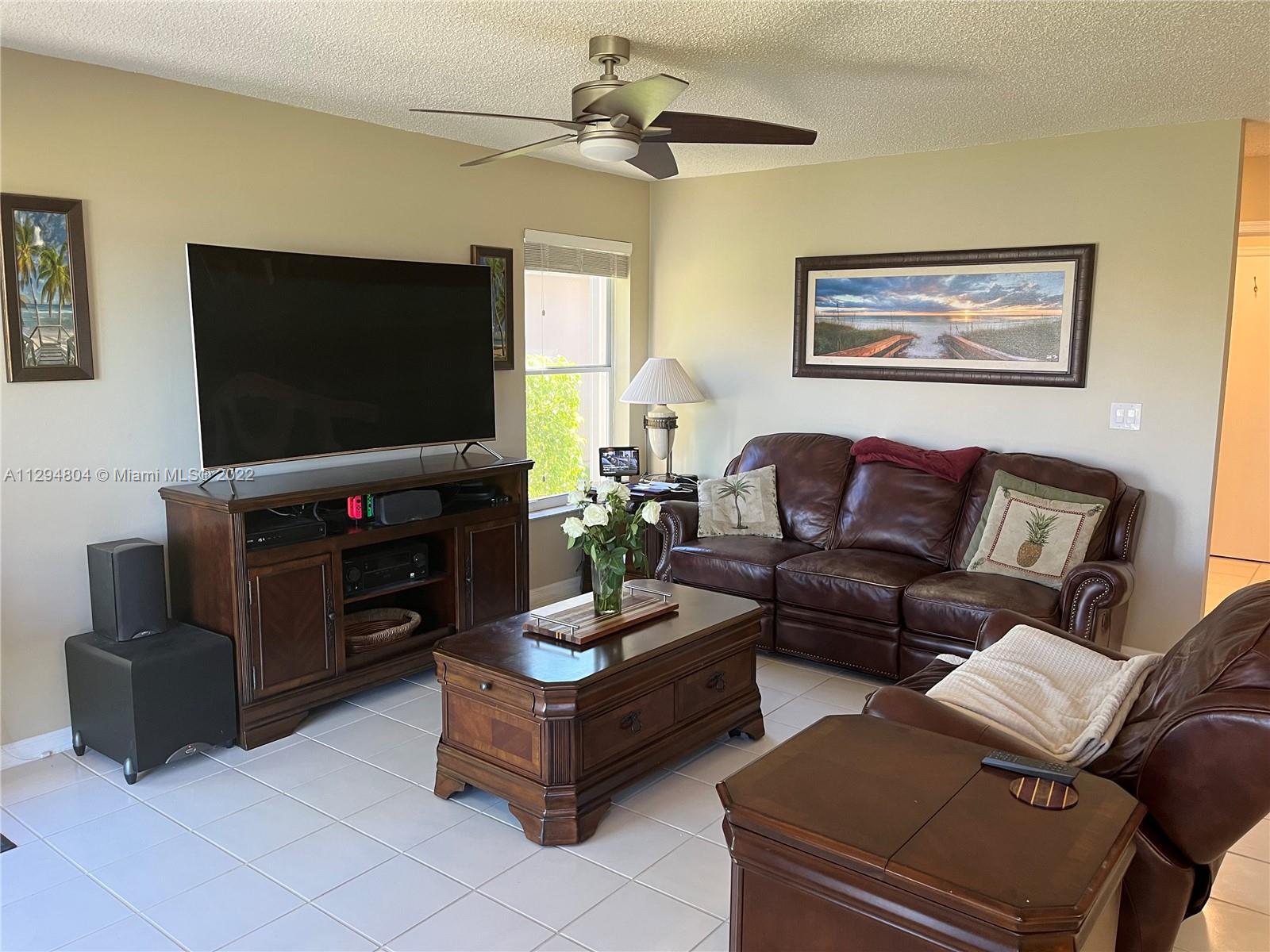 18249 Southwest 3rd Street Pembroke Pines, FL 33029 - Photo 3 of 40 a living room with furniture and a flat screen tv