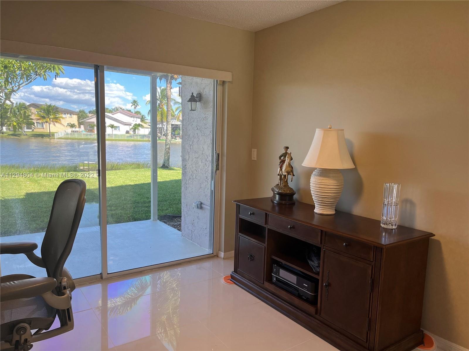 18249 Southwest 3rd Street Pembroke Pines, FL 33029 - Photo 6 of 40 a view of a workspace with furniture and a window