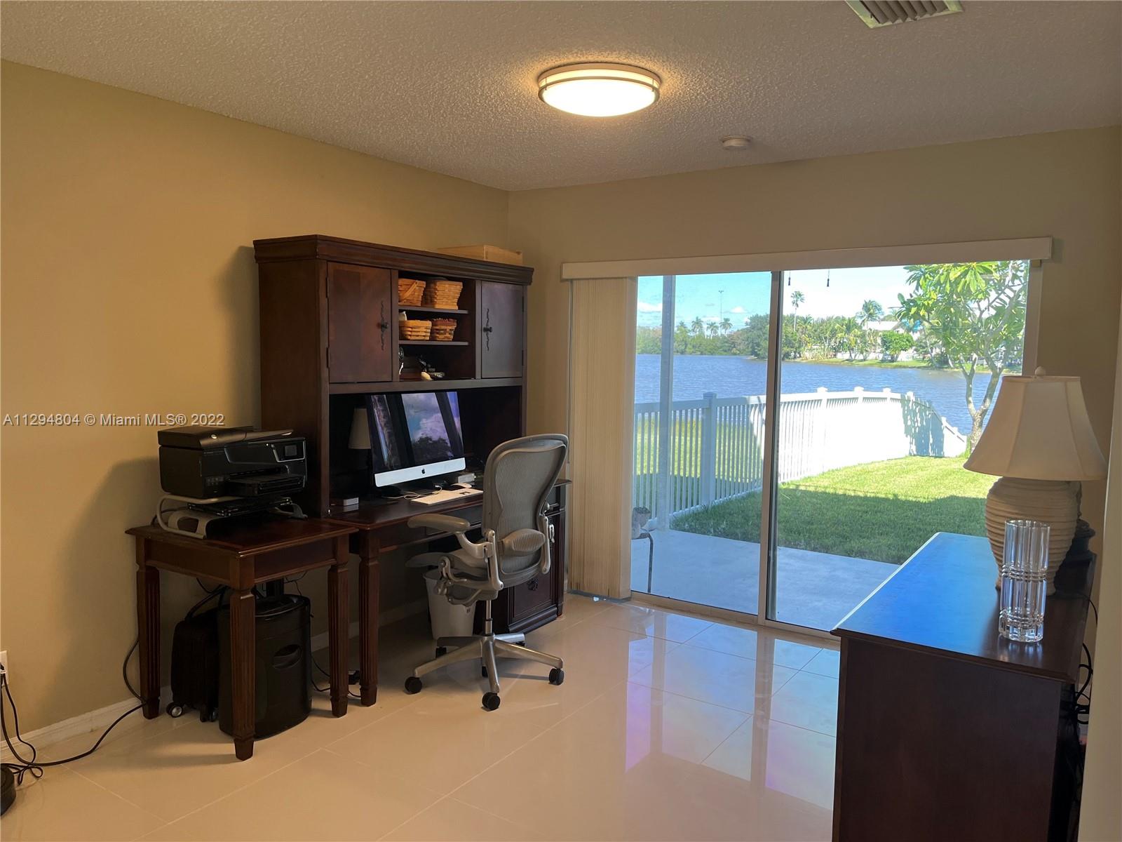 18249 Southwest 3rd Street Pembroke Pines, FL 33029 - Photo 7 of 40 a view of a workspace with furniture and a window