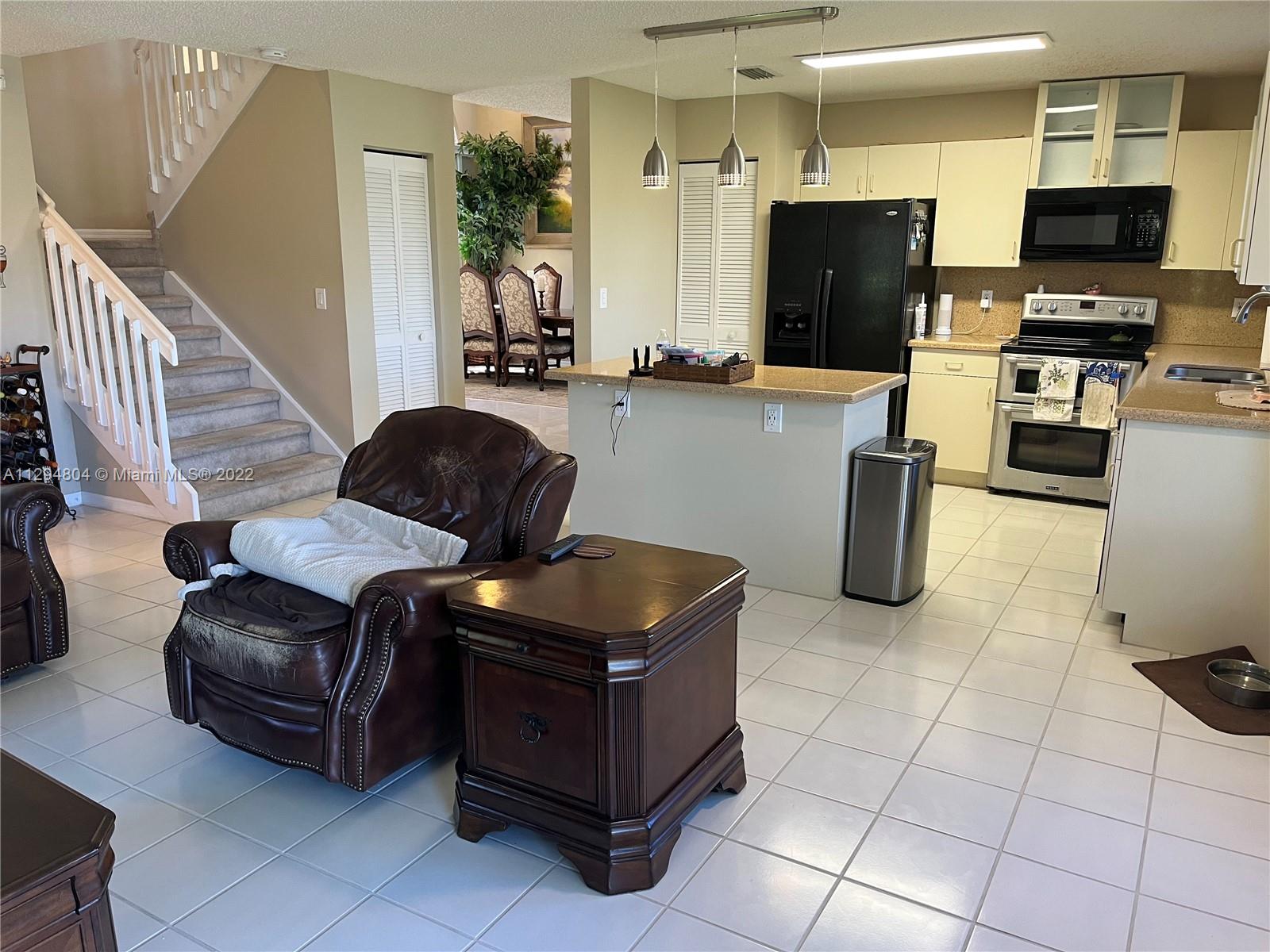 18249 Southwest 3rd Street Pembroke Pines, FL 33029 - Photo 9 of 40 a living room with furniture and a flat screen tv