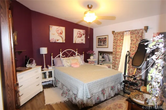 a patio with table and chairs and potted plants