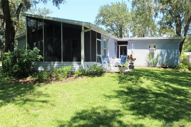 a view of a house with a backyard and garden