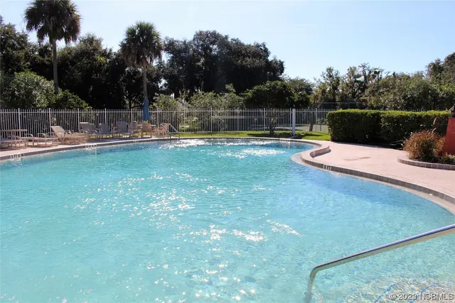 an aerial view of a house with swimming pool and outdoor space