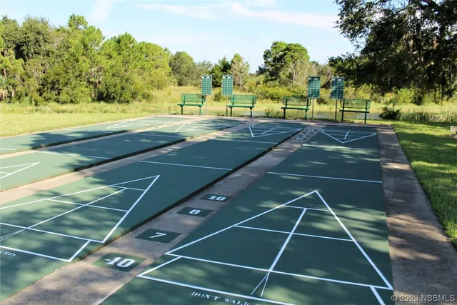 a view of a patio with a table chairs and a fire pit