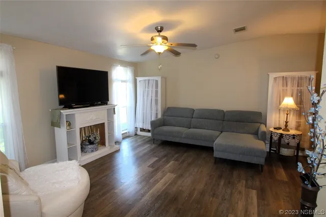 a dining table with chairs and kitchen view
