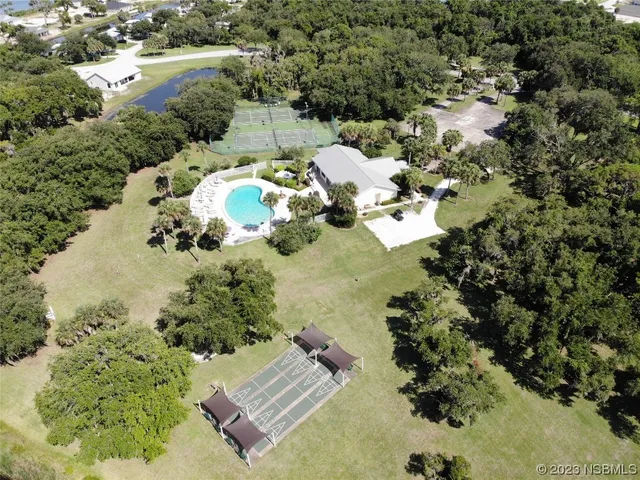a backyard of a house with table and chairs