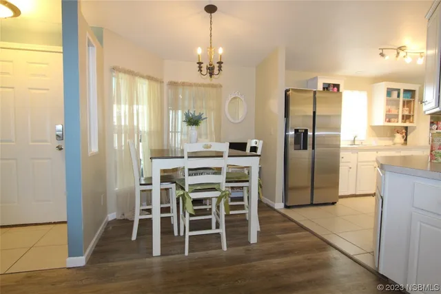 a view of a dining room with furniture and a potted plant