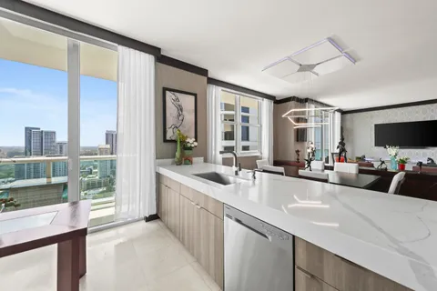 a kitchen with stainless steel appliances white cabinets and a refrigerator