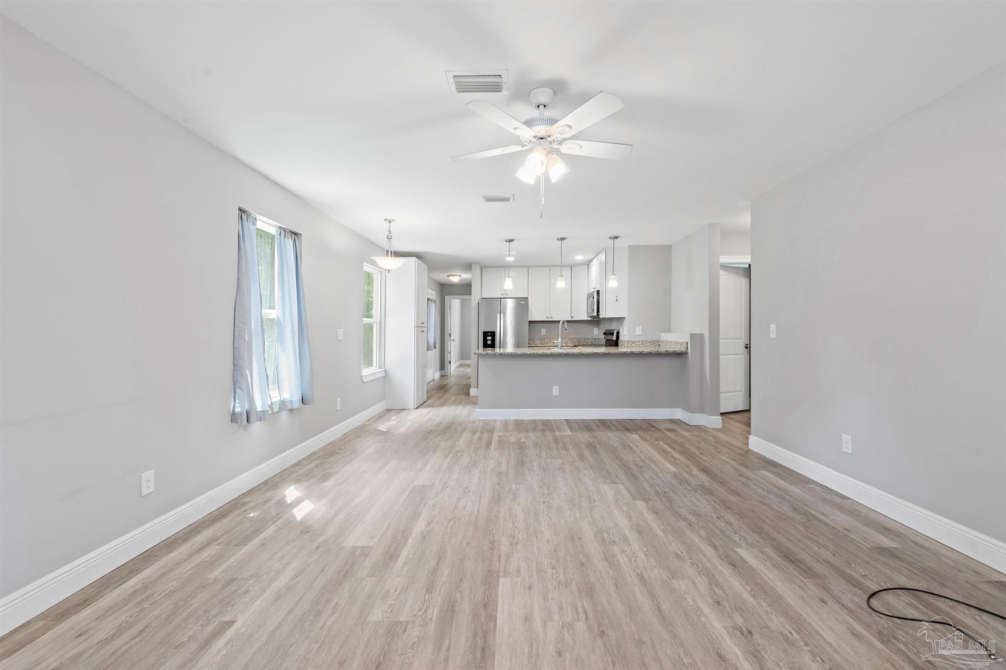 a view of kitchen with wooden floor and window