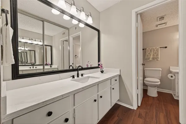 a spacious bathroom with a double vanity sink and a mirror