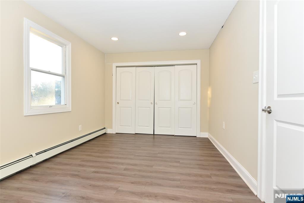 105 Parkway Rochelle Park, NJ 07662 - Photo 14 of 22 a view of an empty room with wooden floor and a window